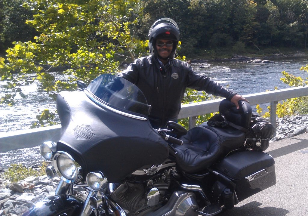 Dr. Lynch standing with motorcycle